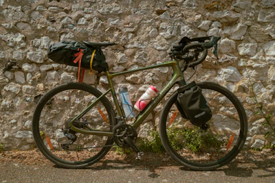 a bike parked next to a stone wall
