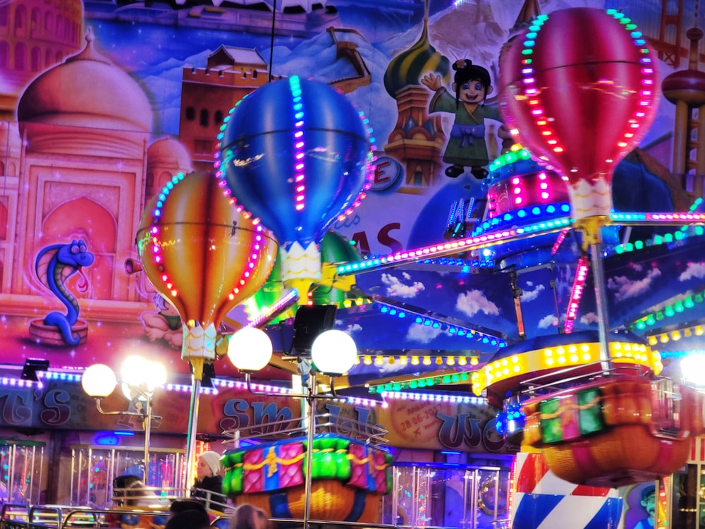 a carnival ride at night with colorful lights