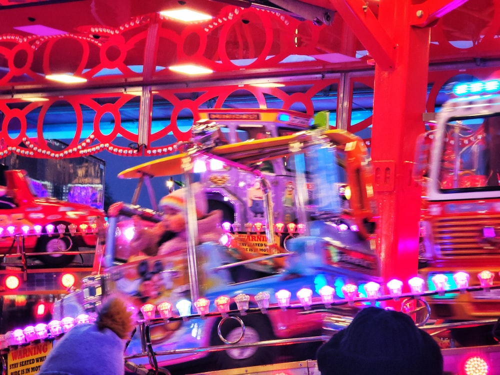 a carnival ride with people riding it at night