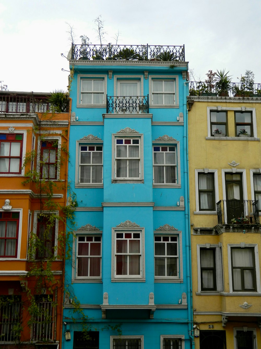 a tall blue building with lots of windows