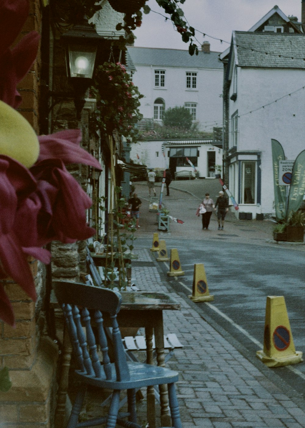 a couple of blue chairs sitting on the side of a road