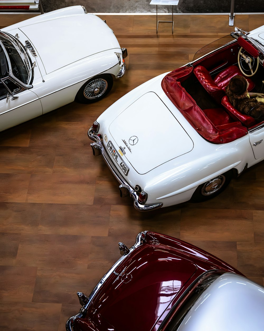 a group of cars parked next to each other on a hard wood floor