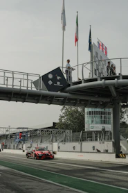 a car driving down a road under a bridge
