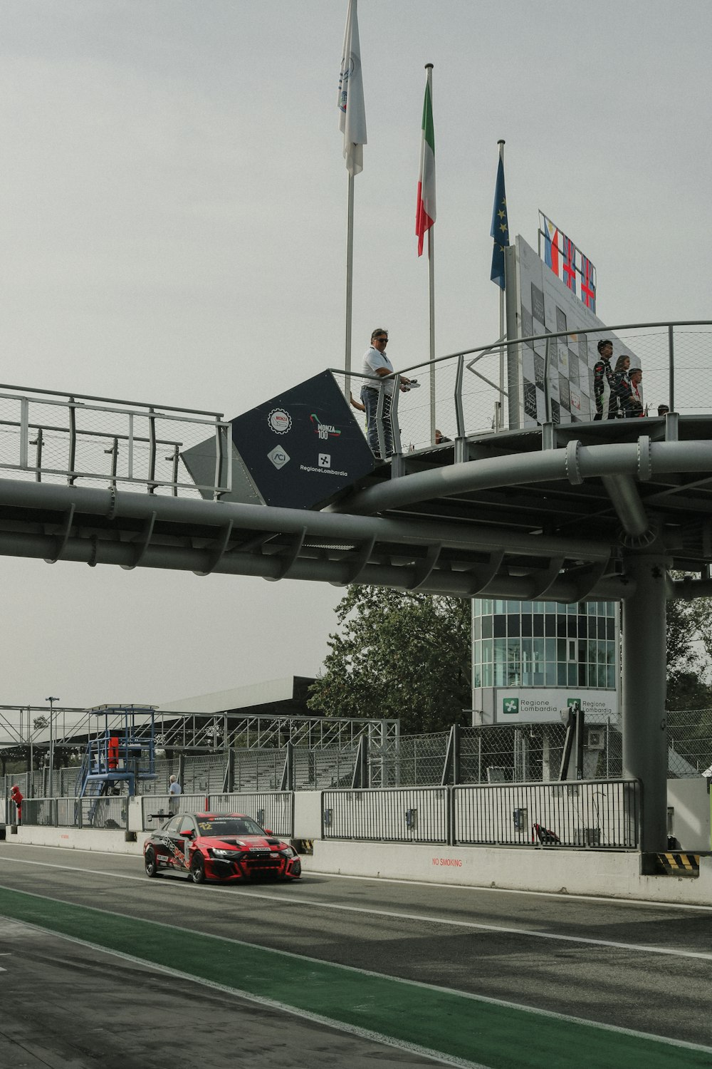 a car driving down a road under a bridge