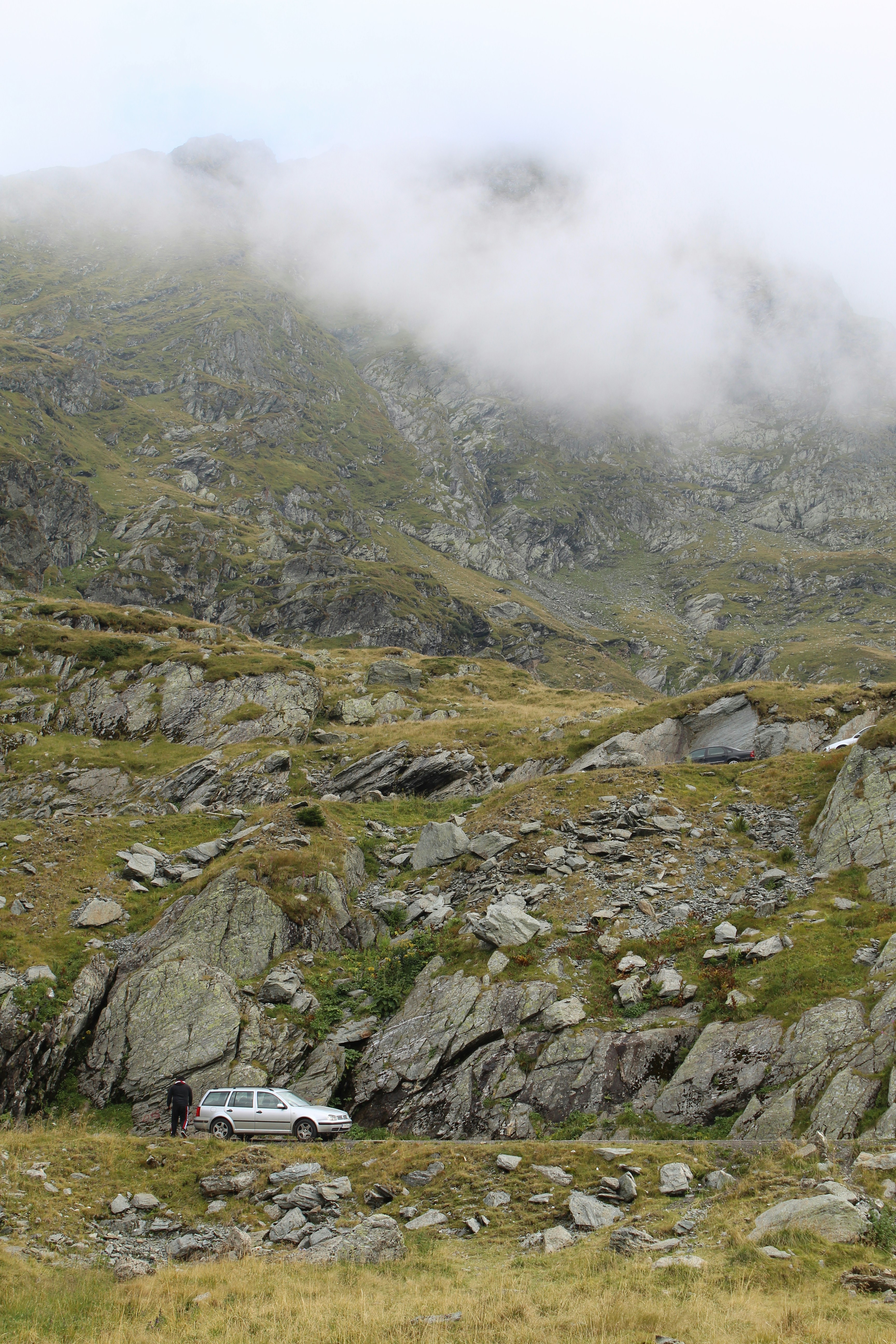 a car is parked on a rocky hillside