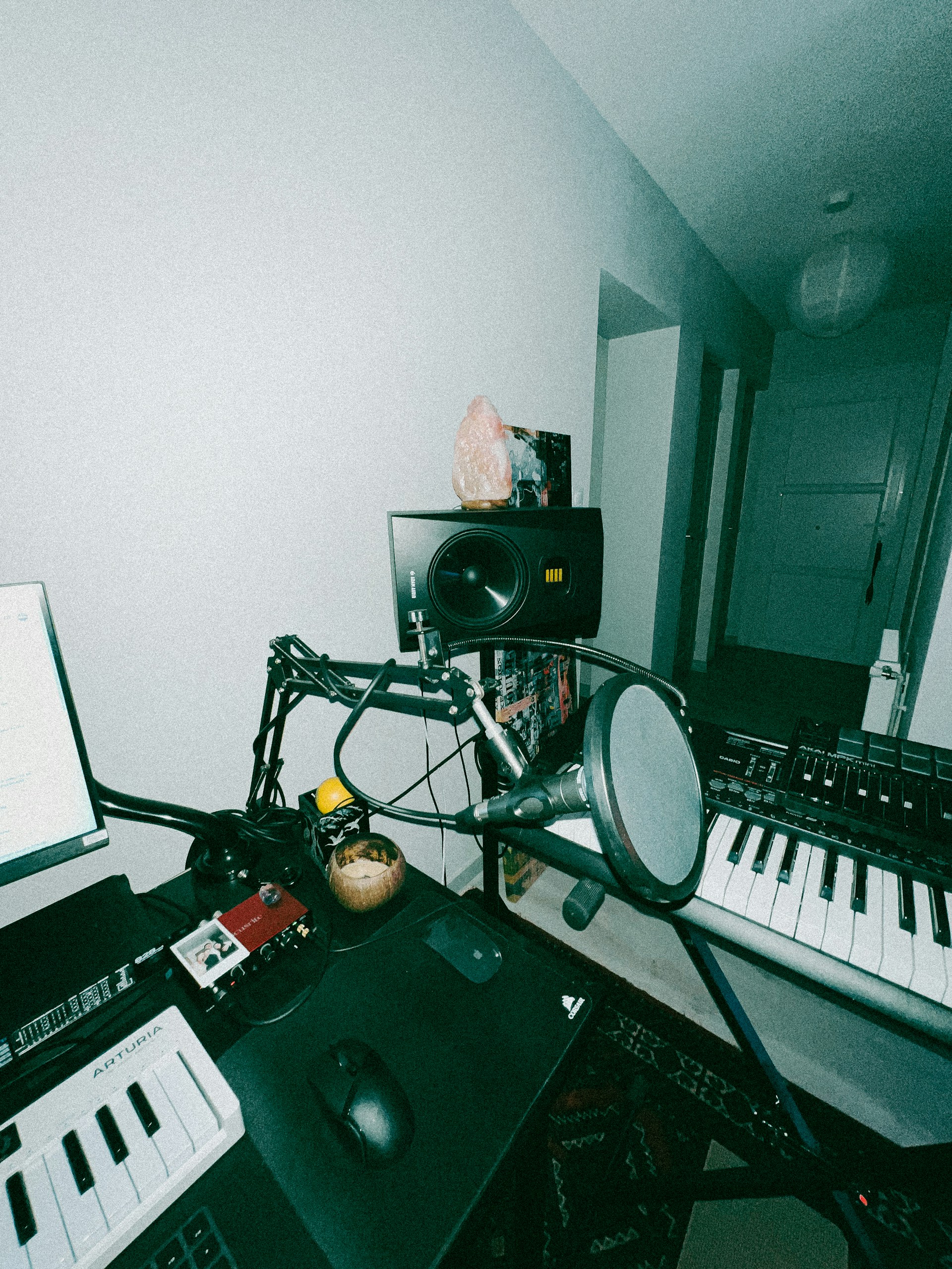 a recording studio with a laptop and a keyboard