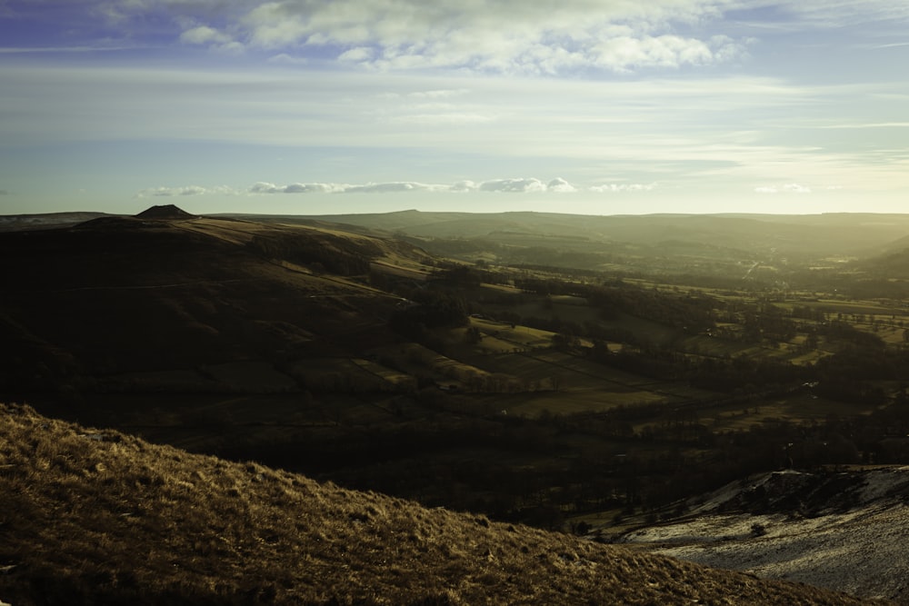 a view of a valley with hills in the distance