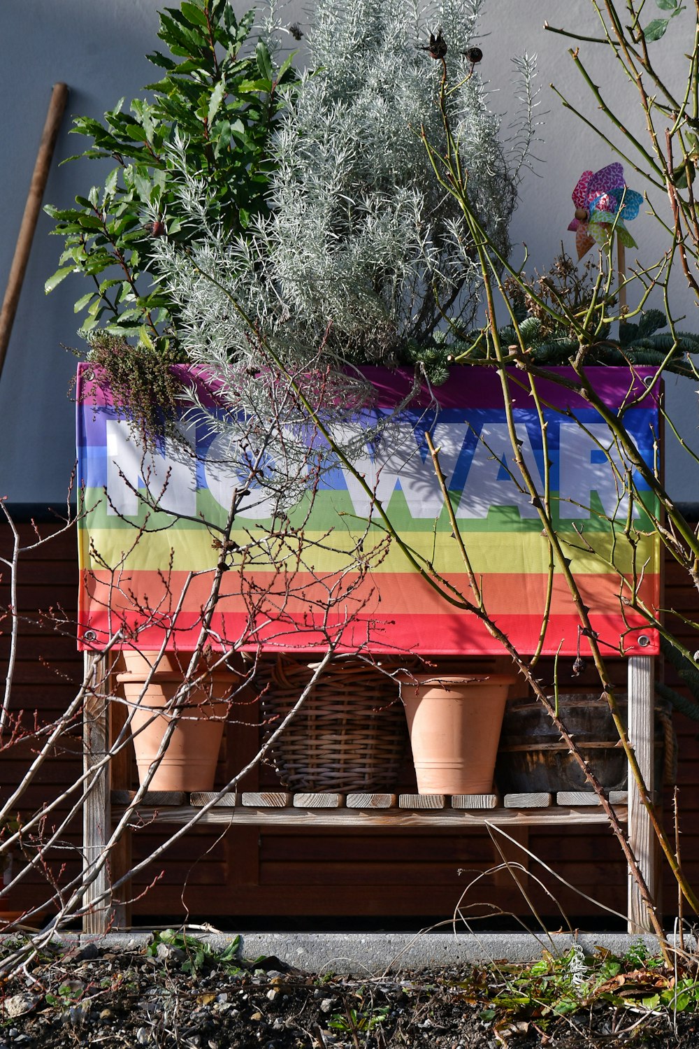 a bench with potted plants on top of it