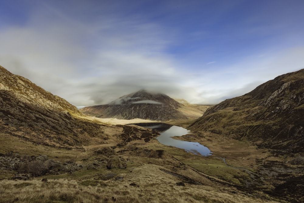 a mountain range with a lake in the foreground