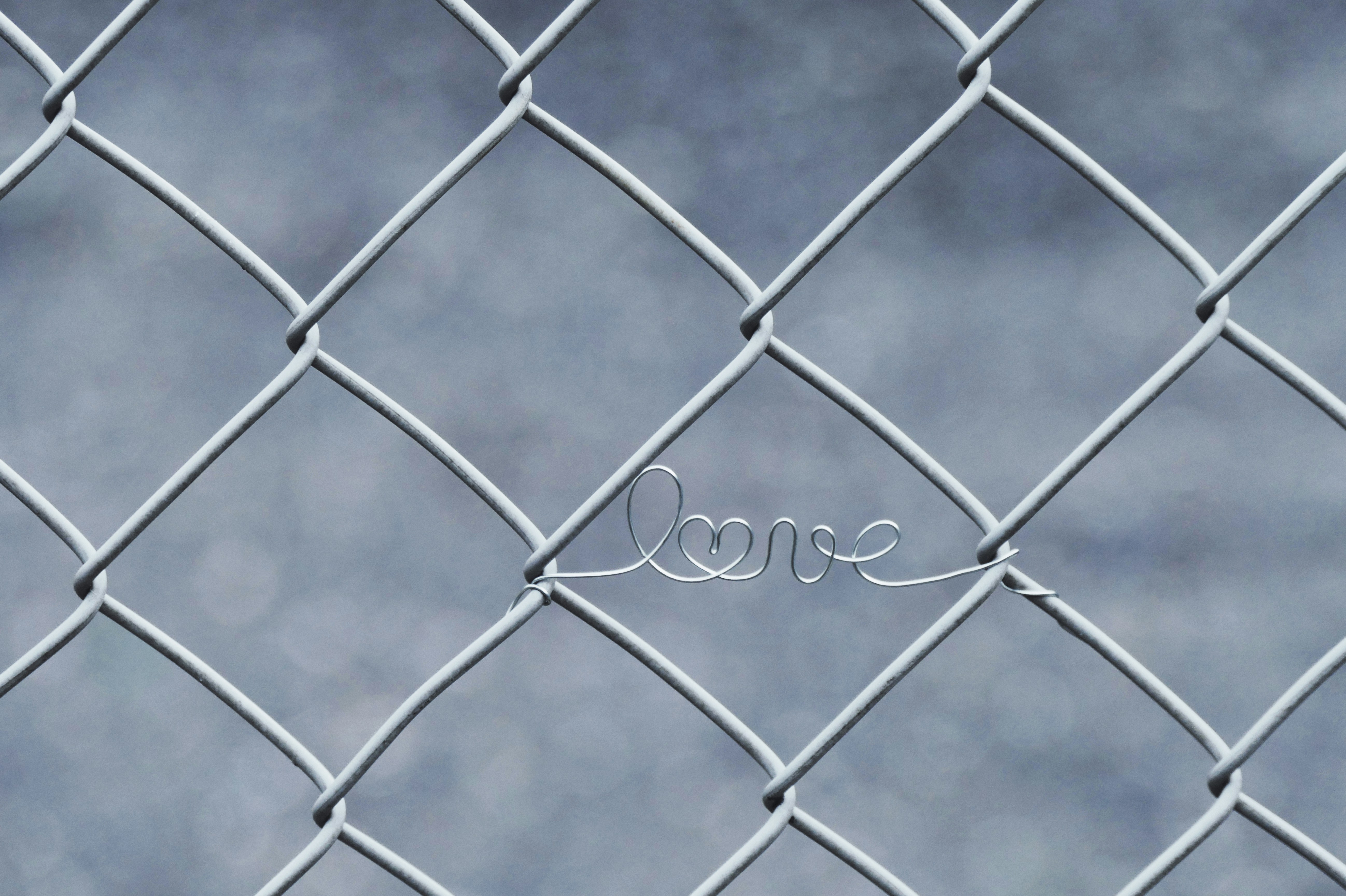 a wire fence with the word love written on it