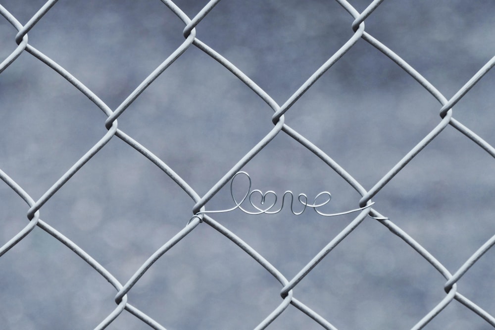 a wire fence with the word love written on it