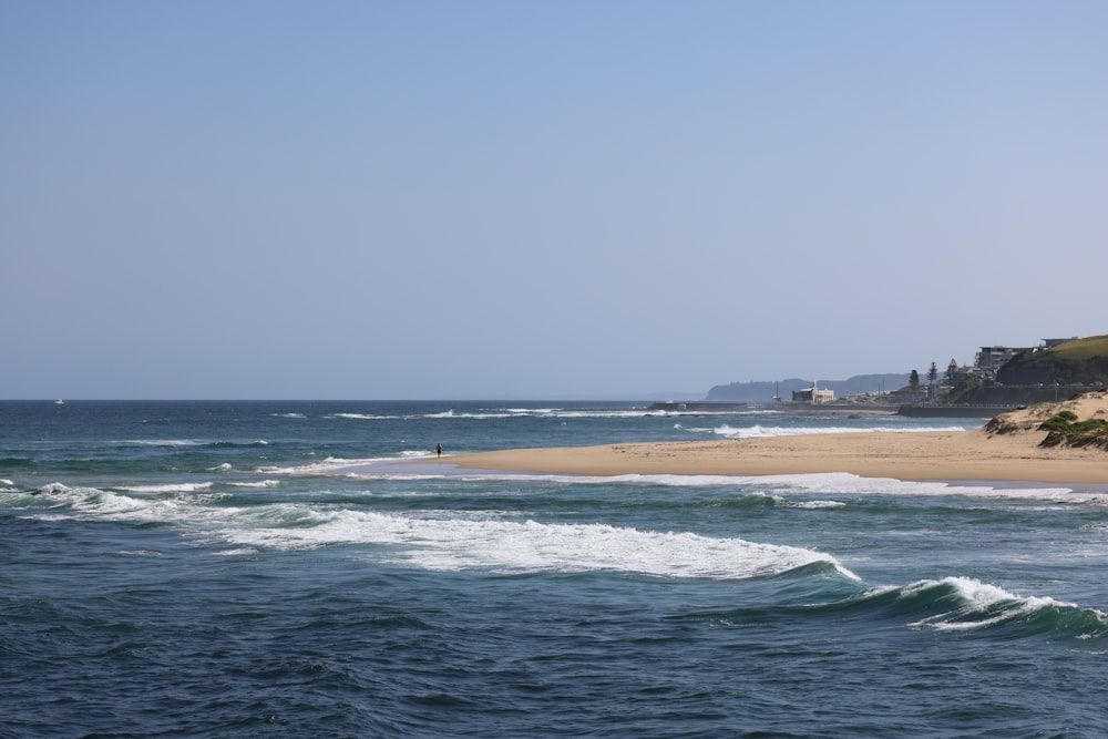 a view of a beach from the ocean