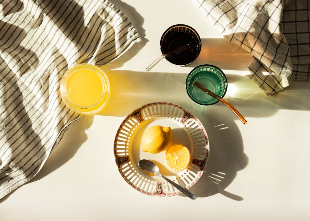 un bol de citrons et un verre de jus d’orange