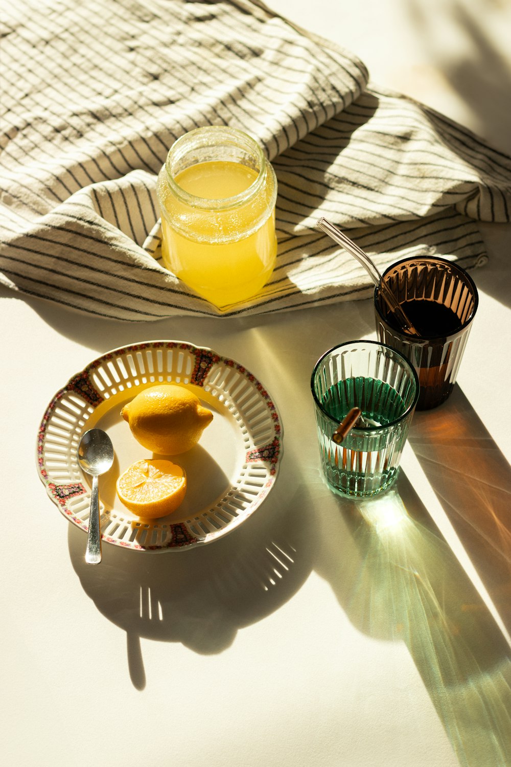 a glass of orange juice next to a plate of orange slices