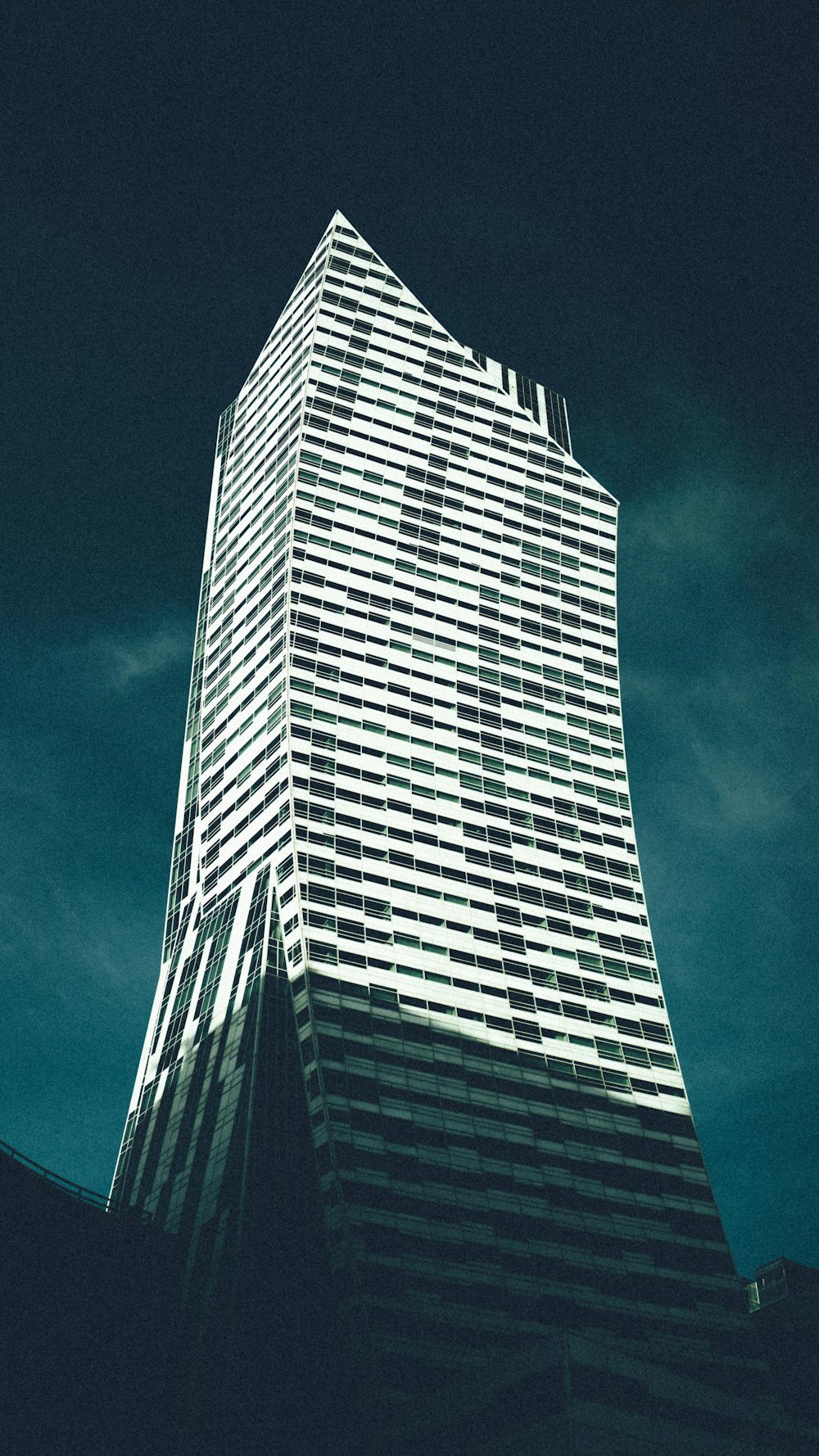 a very tall building with a sky background