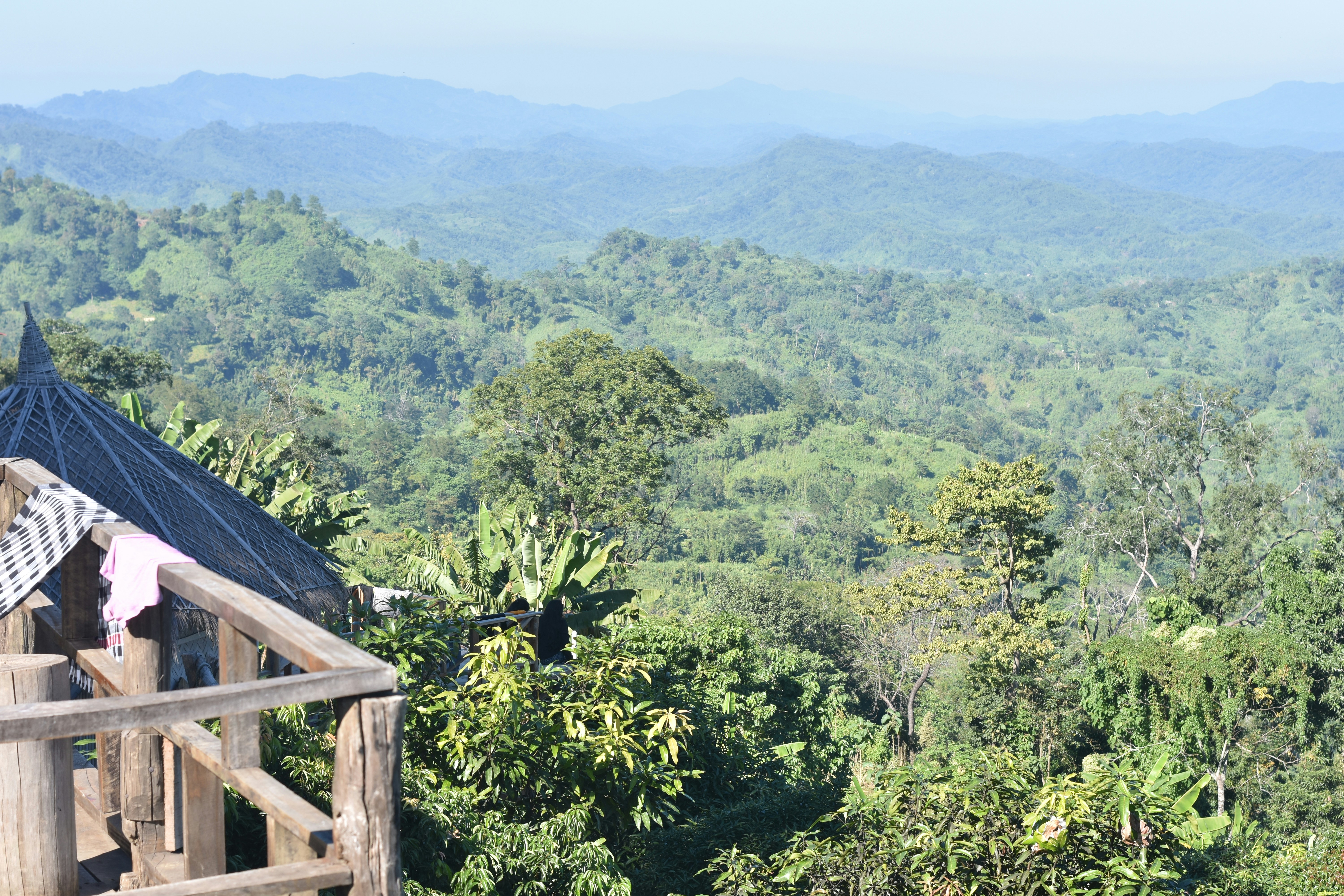 a view of a mountain range with trees and mountains in the background