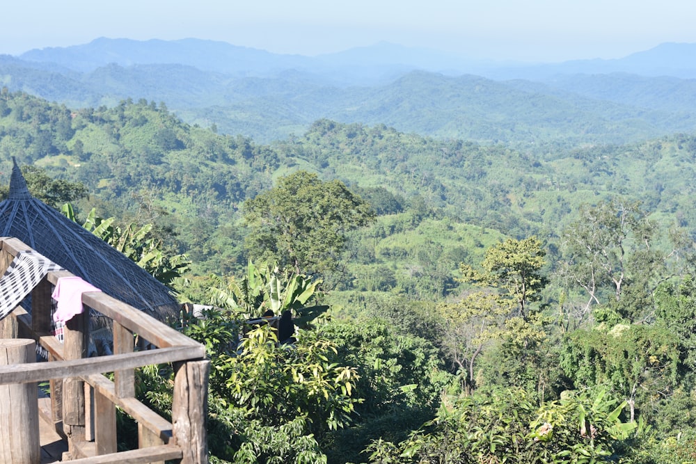 a view of a mountain range with trees and mountains in the background