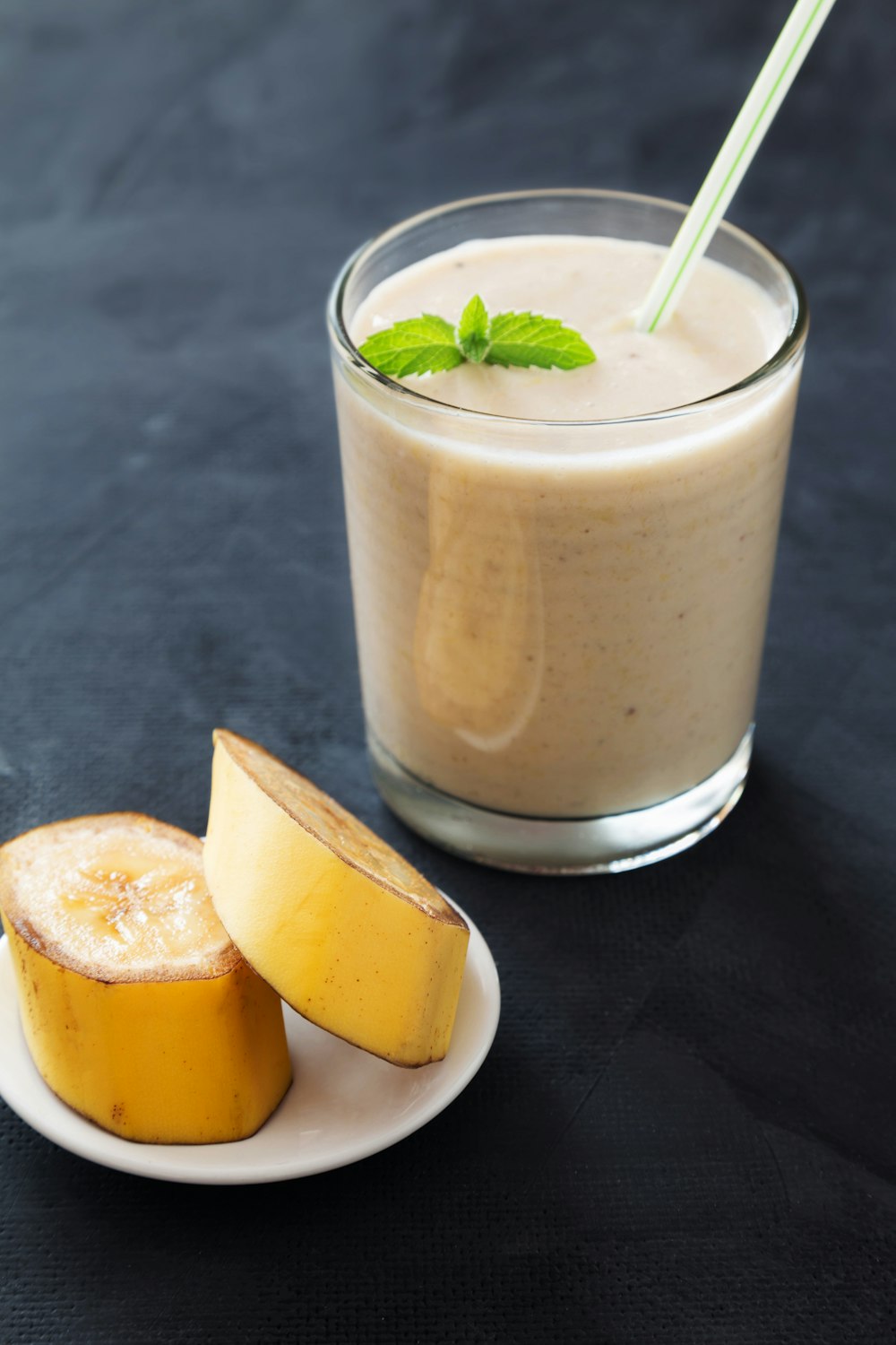 a banana and a glass of smoothie on a table