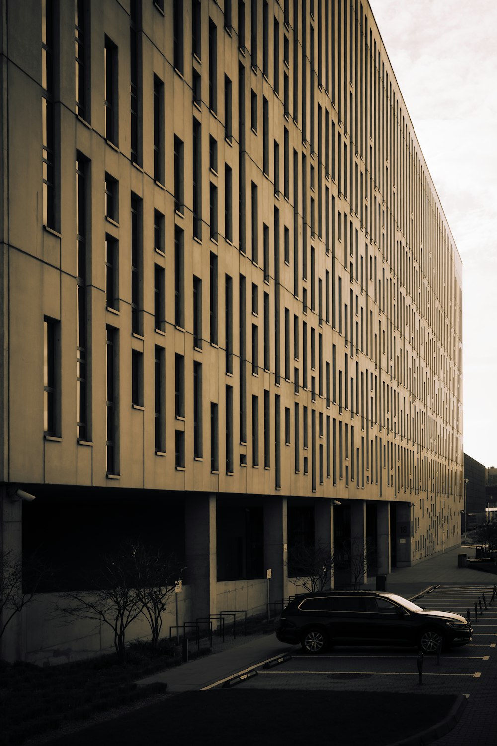 a car parked in front of a tall building