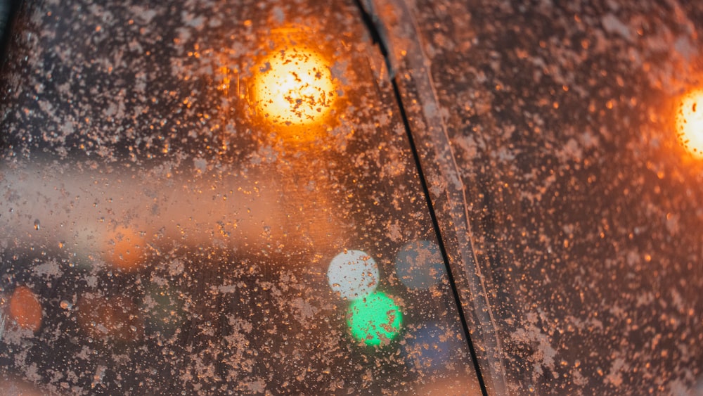 a close up of a traffic light on a rainy day