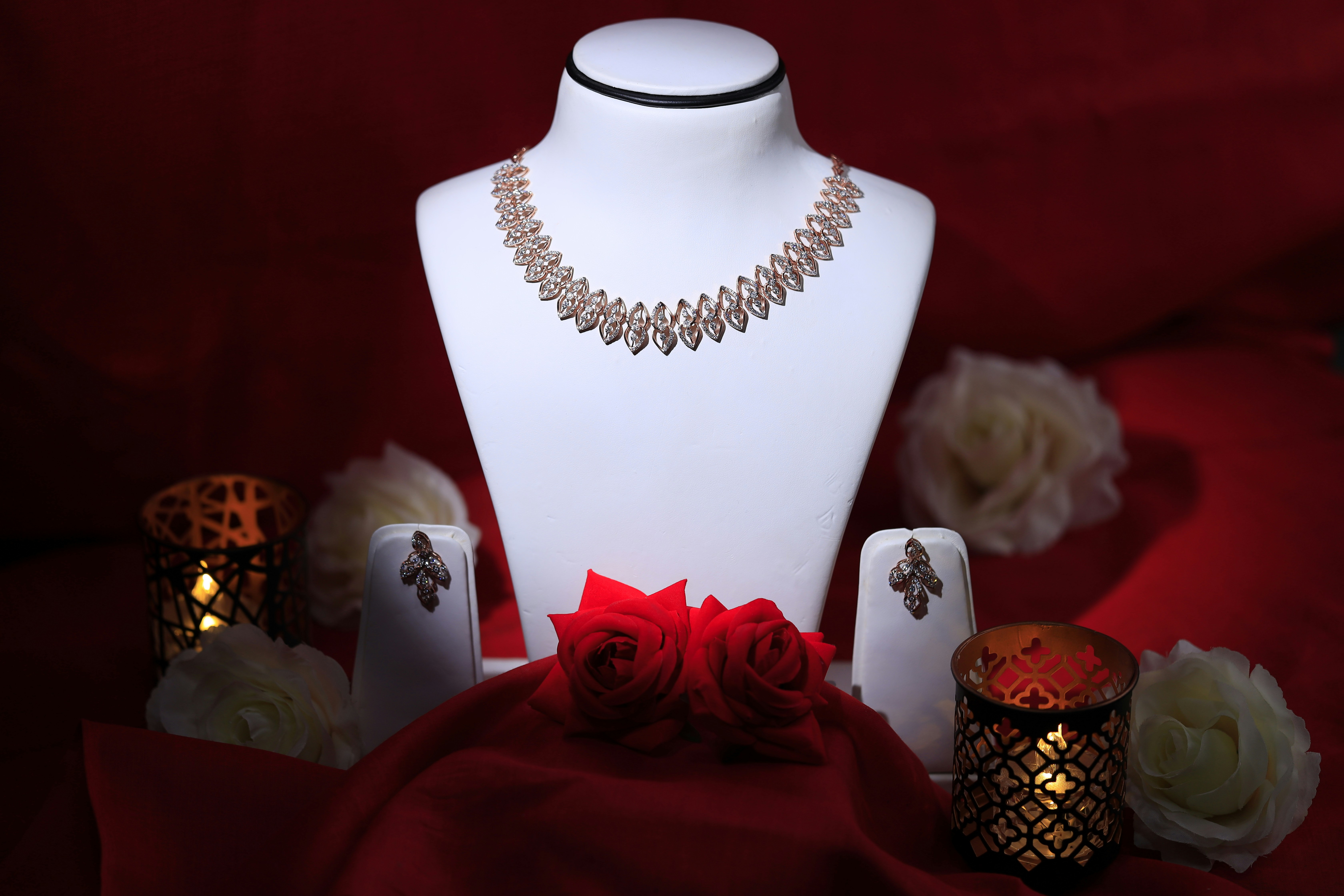 a white mannequin with a red rose on it