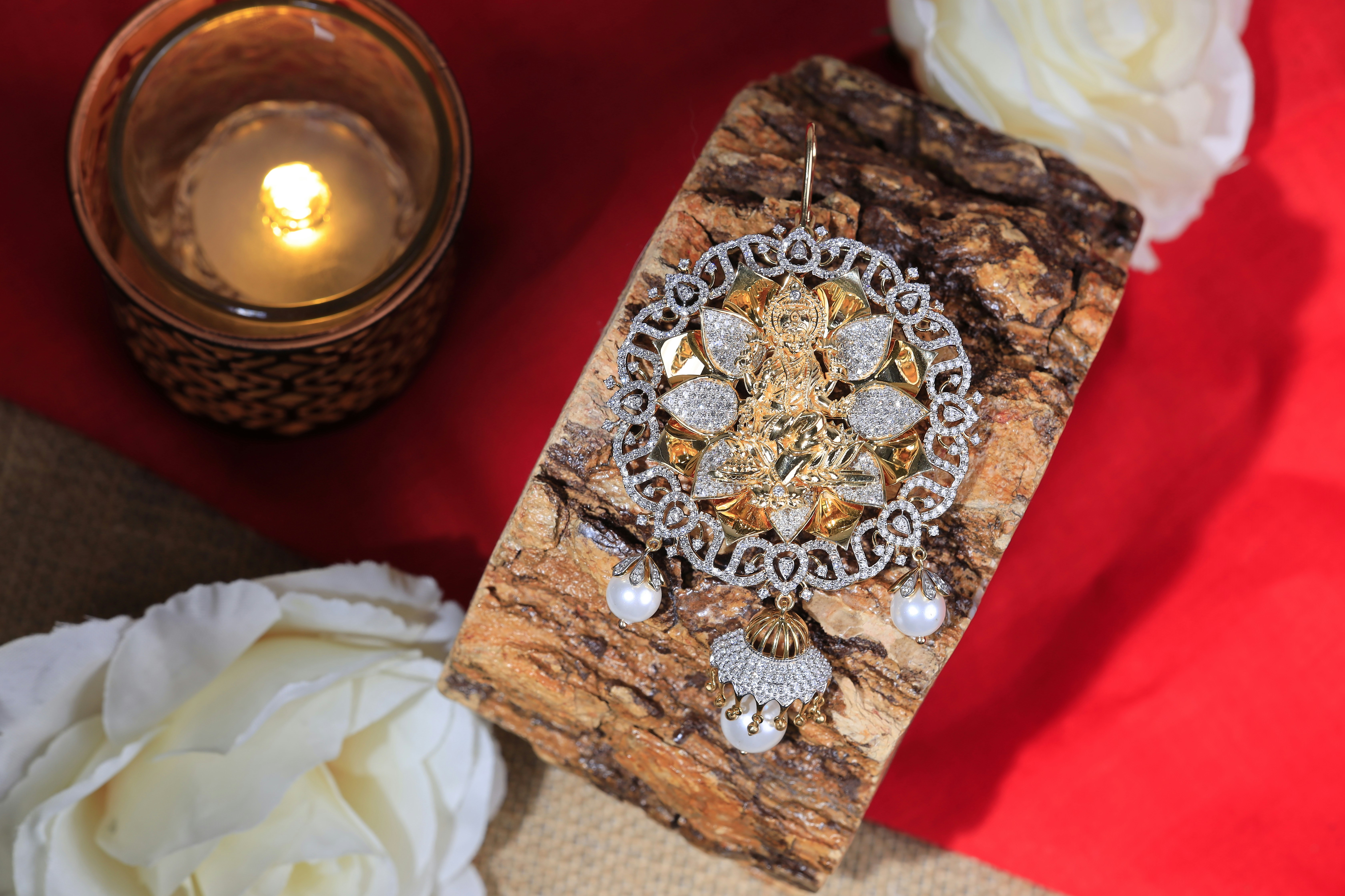a close up of a piece of wood with a candle in the background