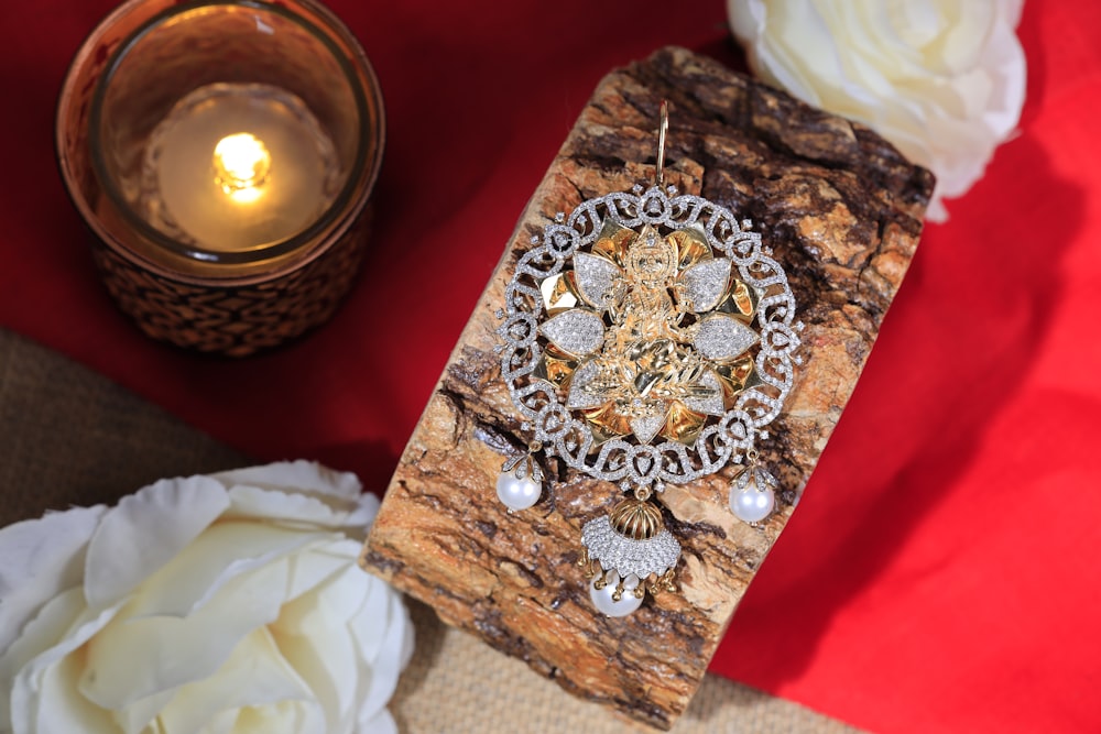 a close up of a piece of wood with a candle in the background