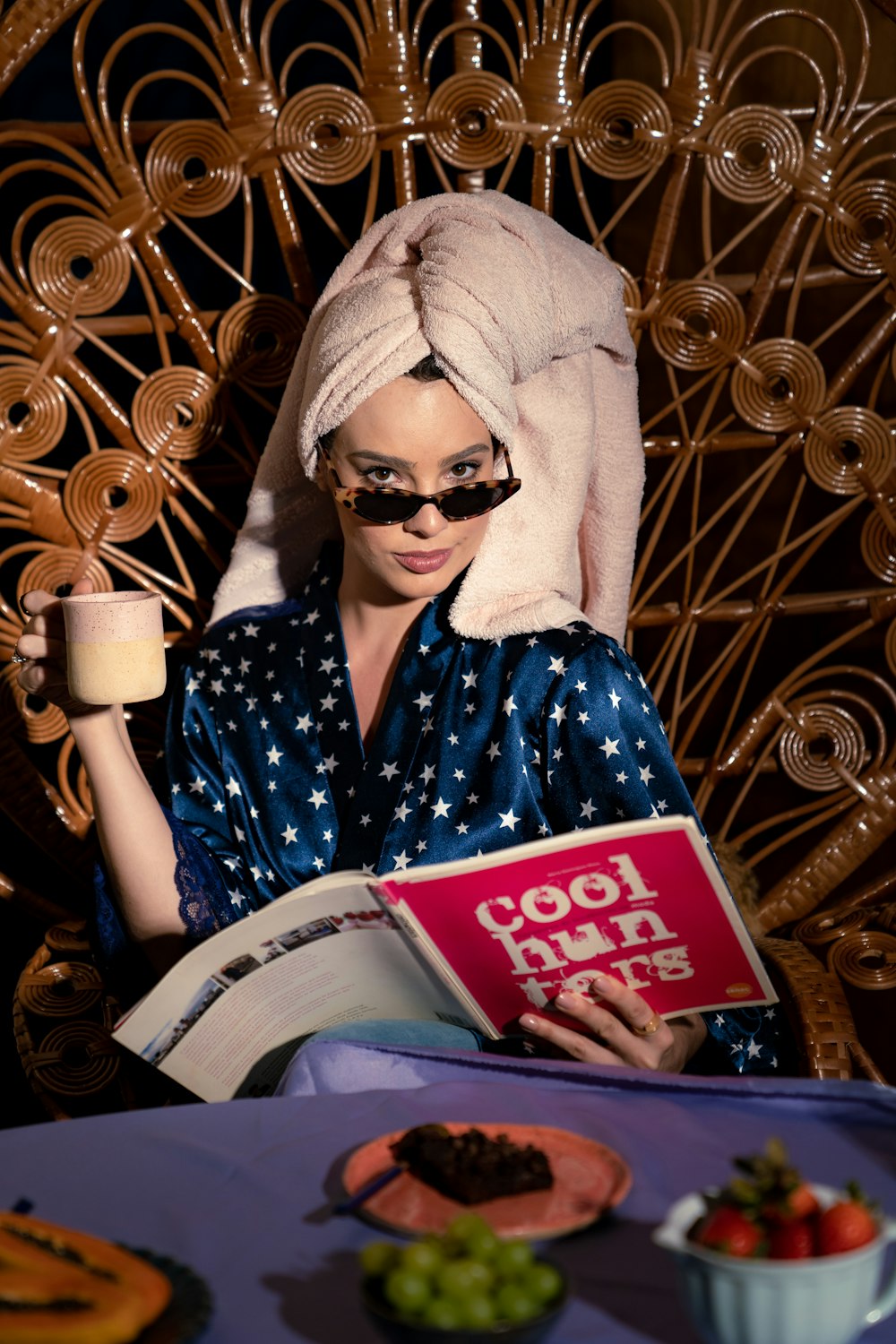 a woman with a towel on her head reading a book