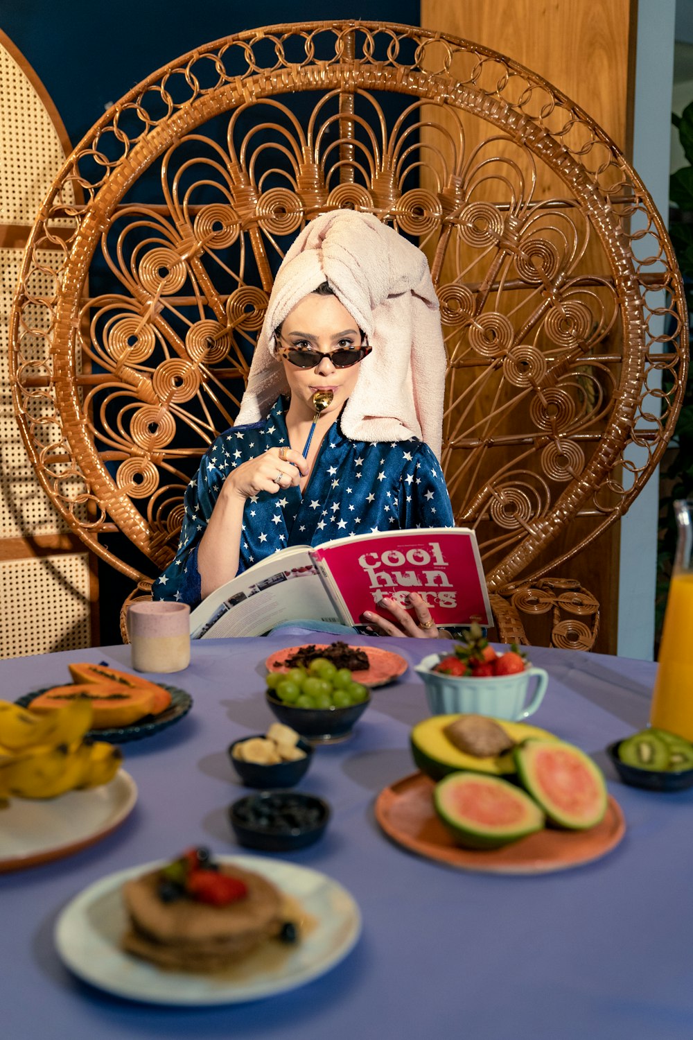 a woman sitting in a chair reading a book