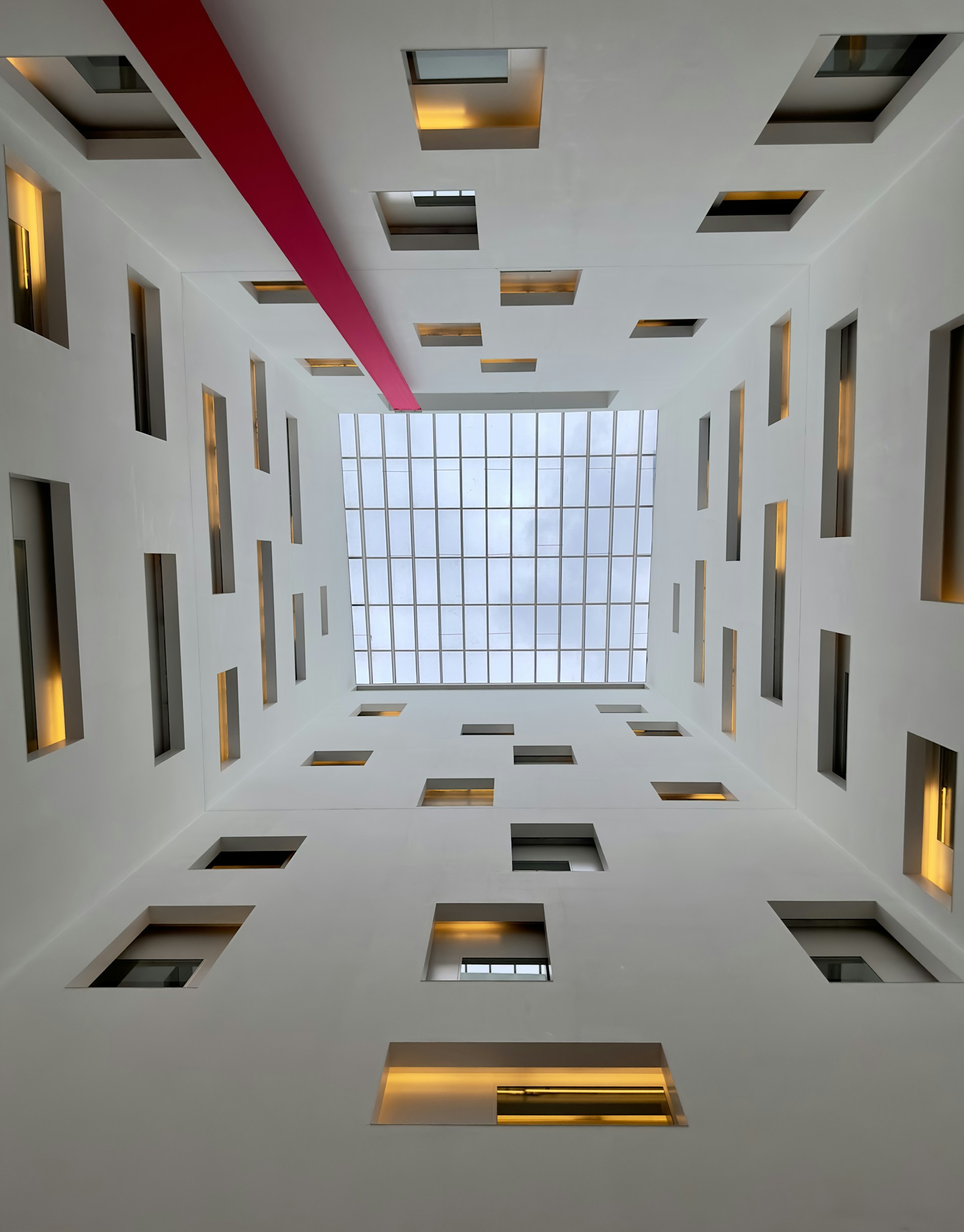 a white room with several square windows and lights