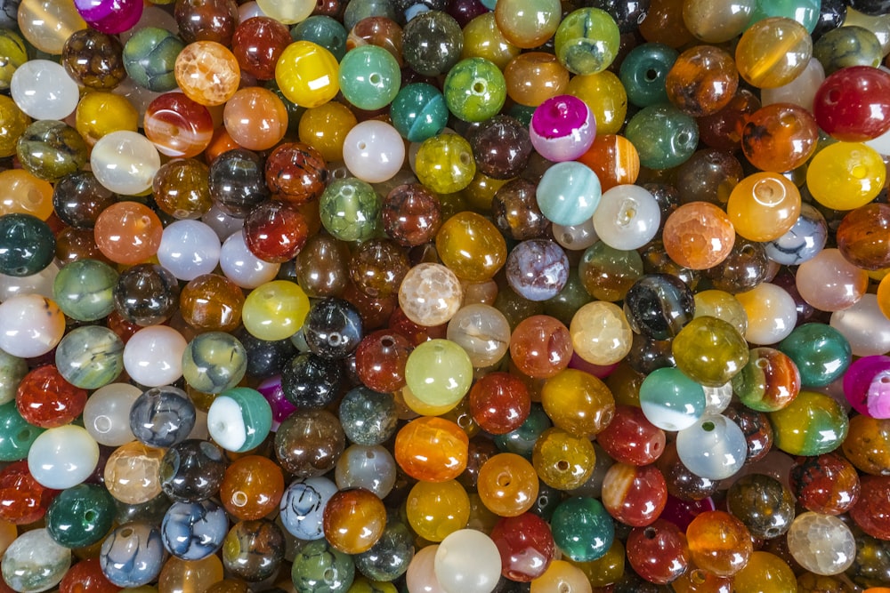 a bunch of different colored marbles in a pile