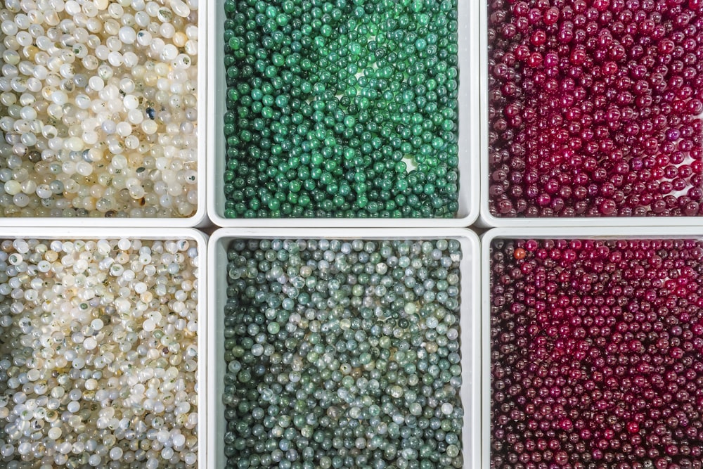 six different colors of beads in a box