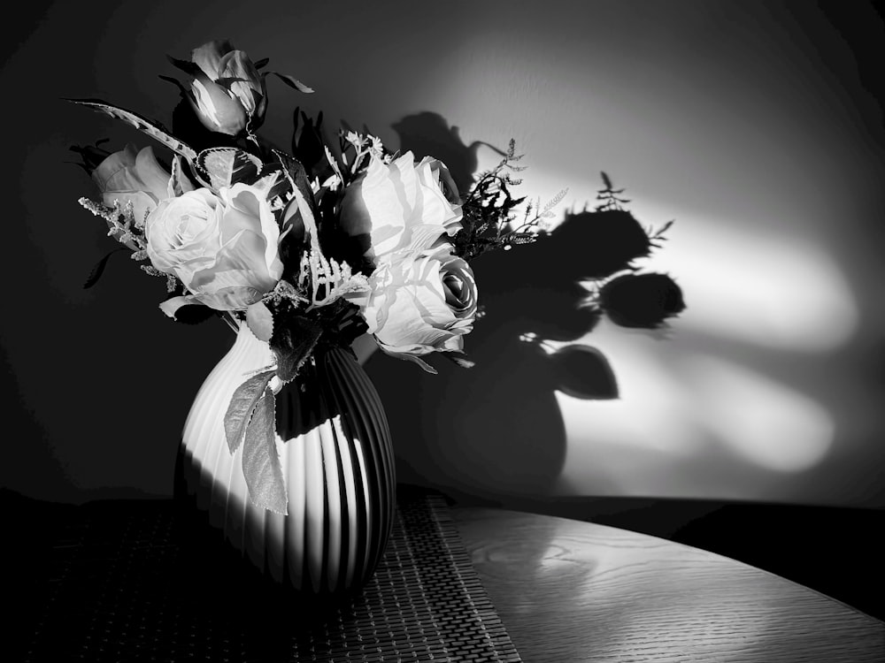 a black and white photo of flowers in a vase