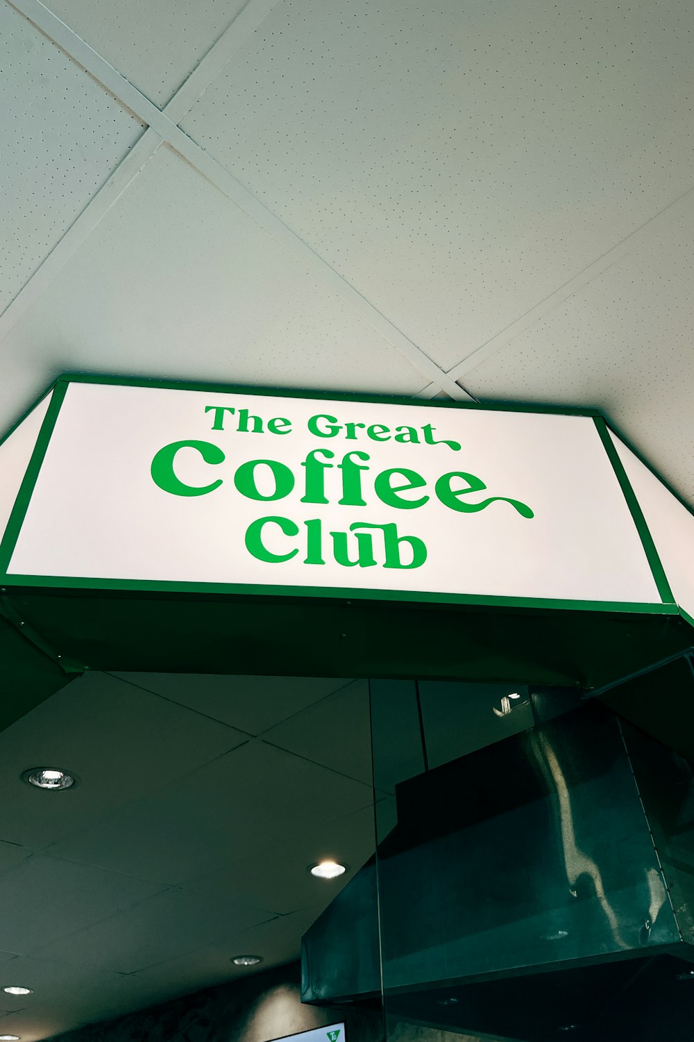 a sign hanging from the ceiling of a coffee shop