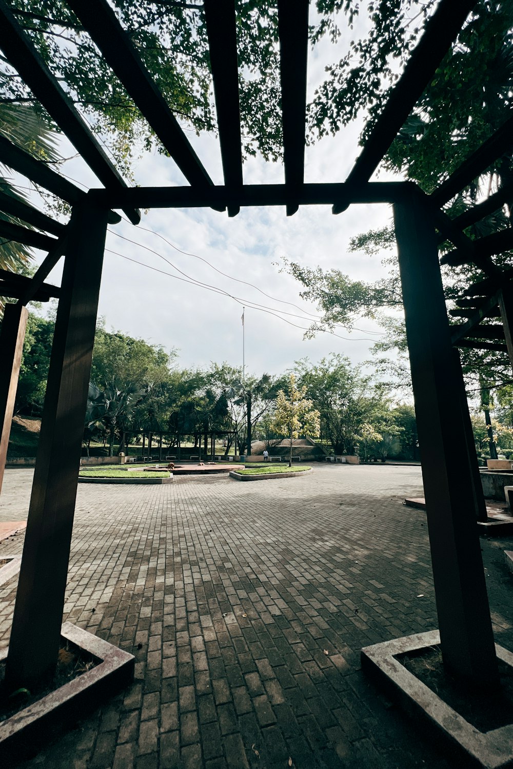 a view of a walkway through a pergolated area