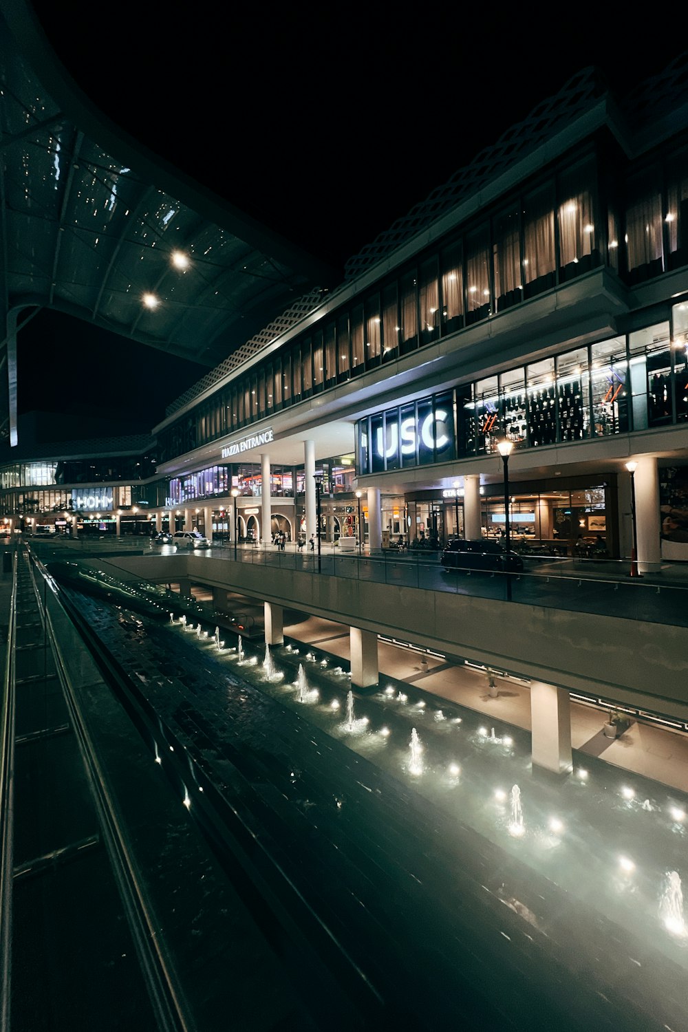 a train station at night with lights on