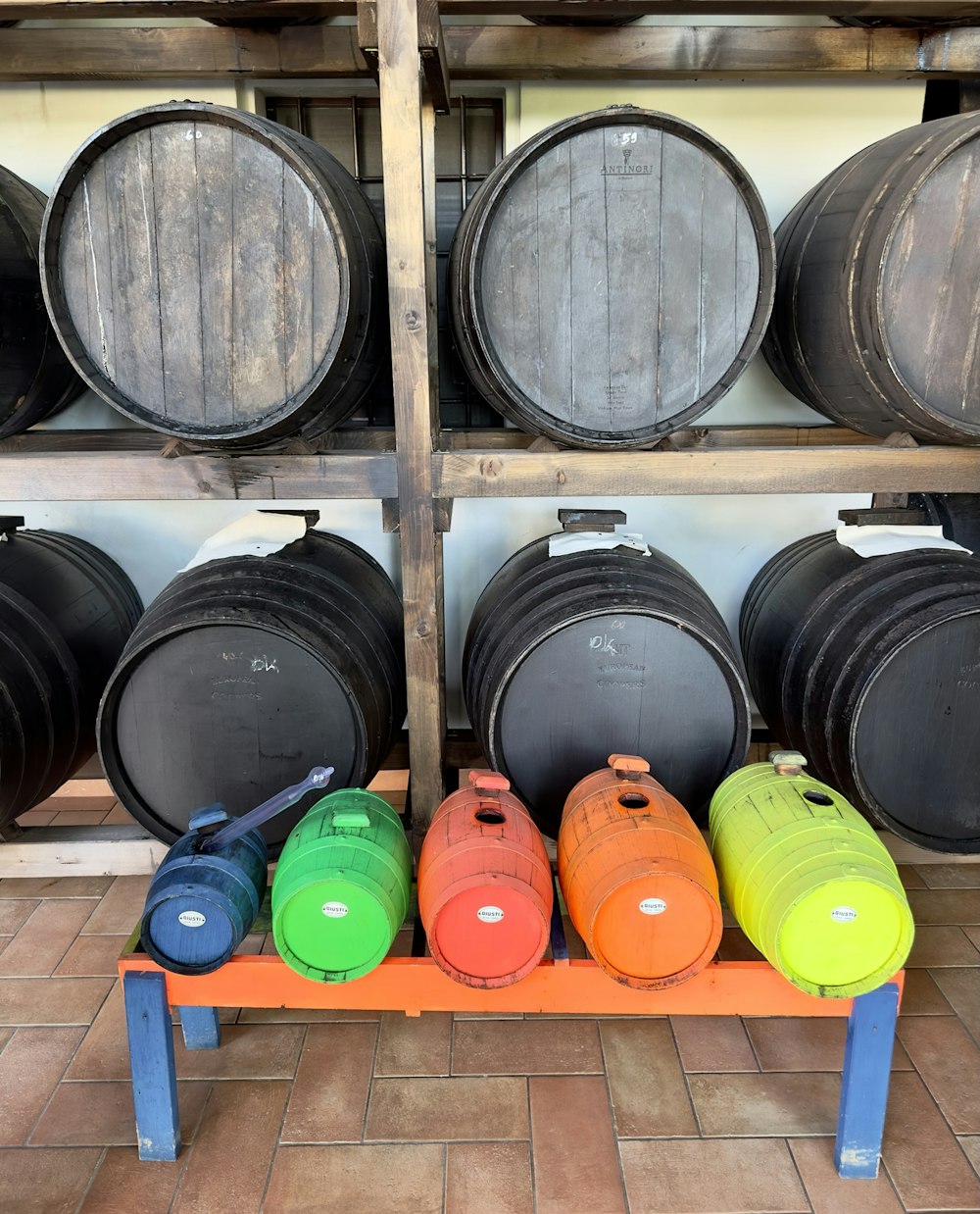 a row of barrels sitting next to each other on a shelf