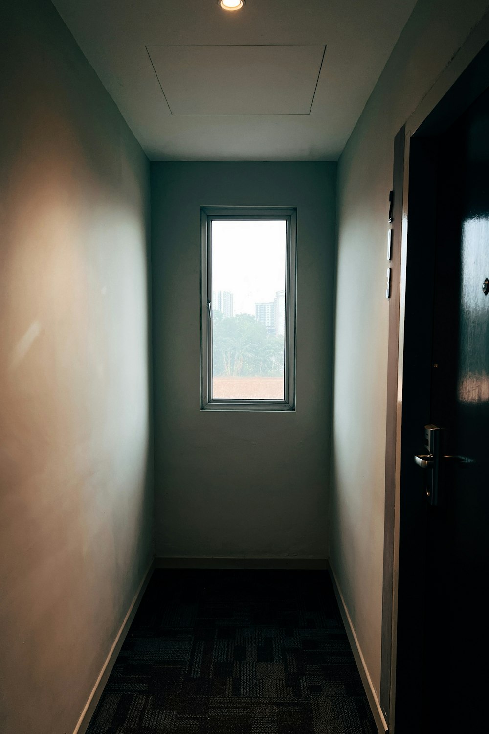 a hallway with a window and a door