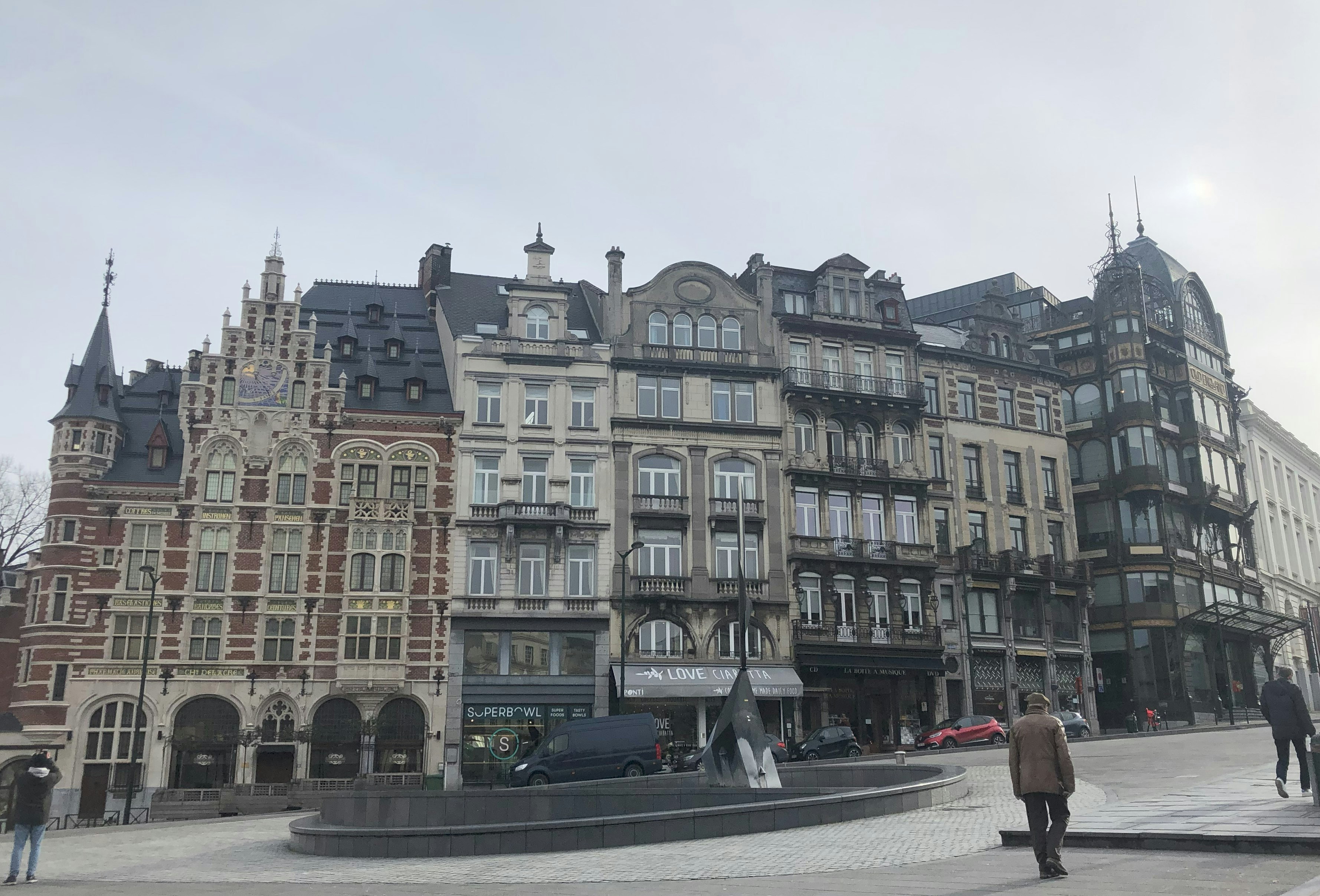 a large building with a fountain in front of it