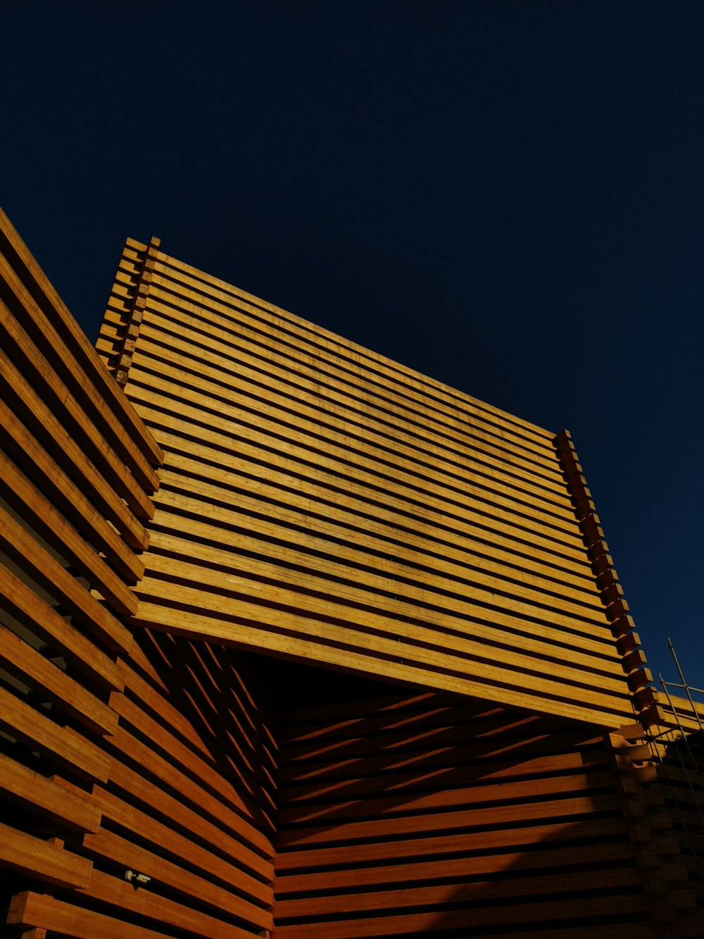 a building made of wooden slats against a blue sky