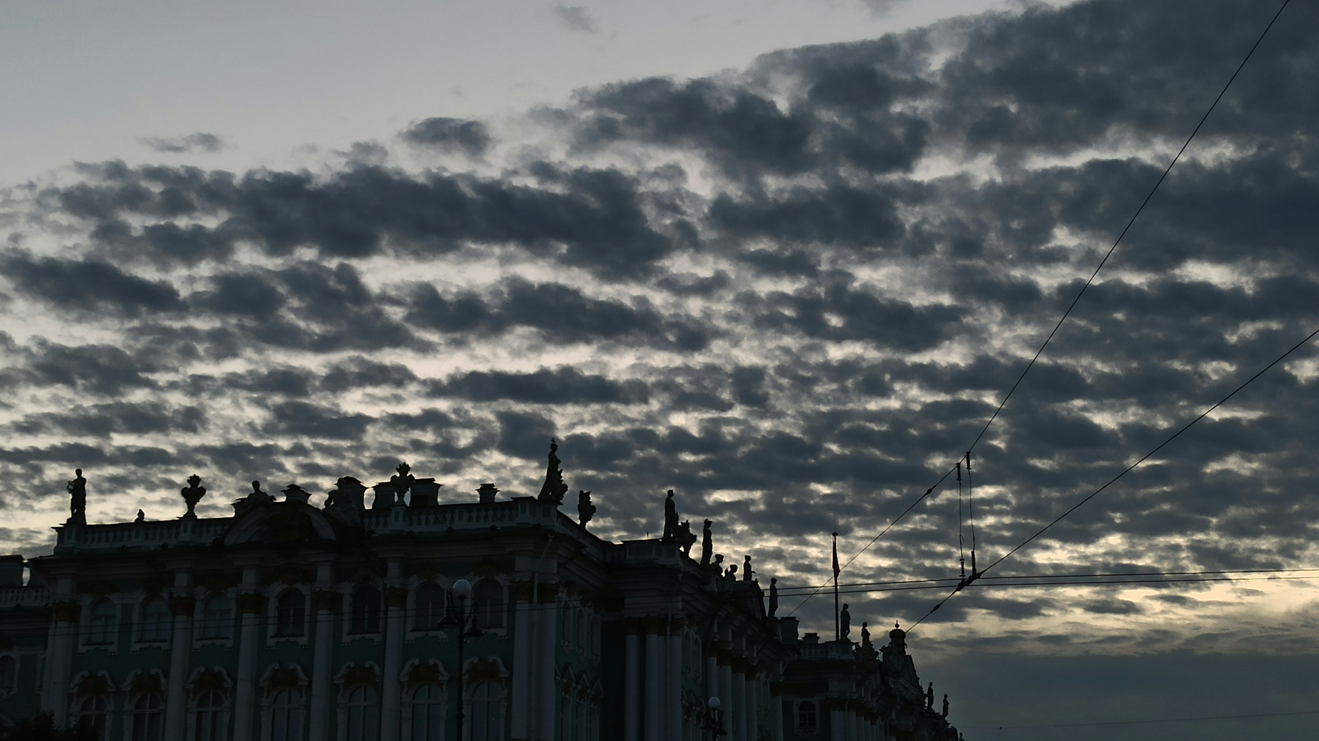 A very tall building under a cloudy sky