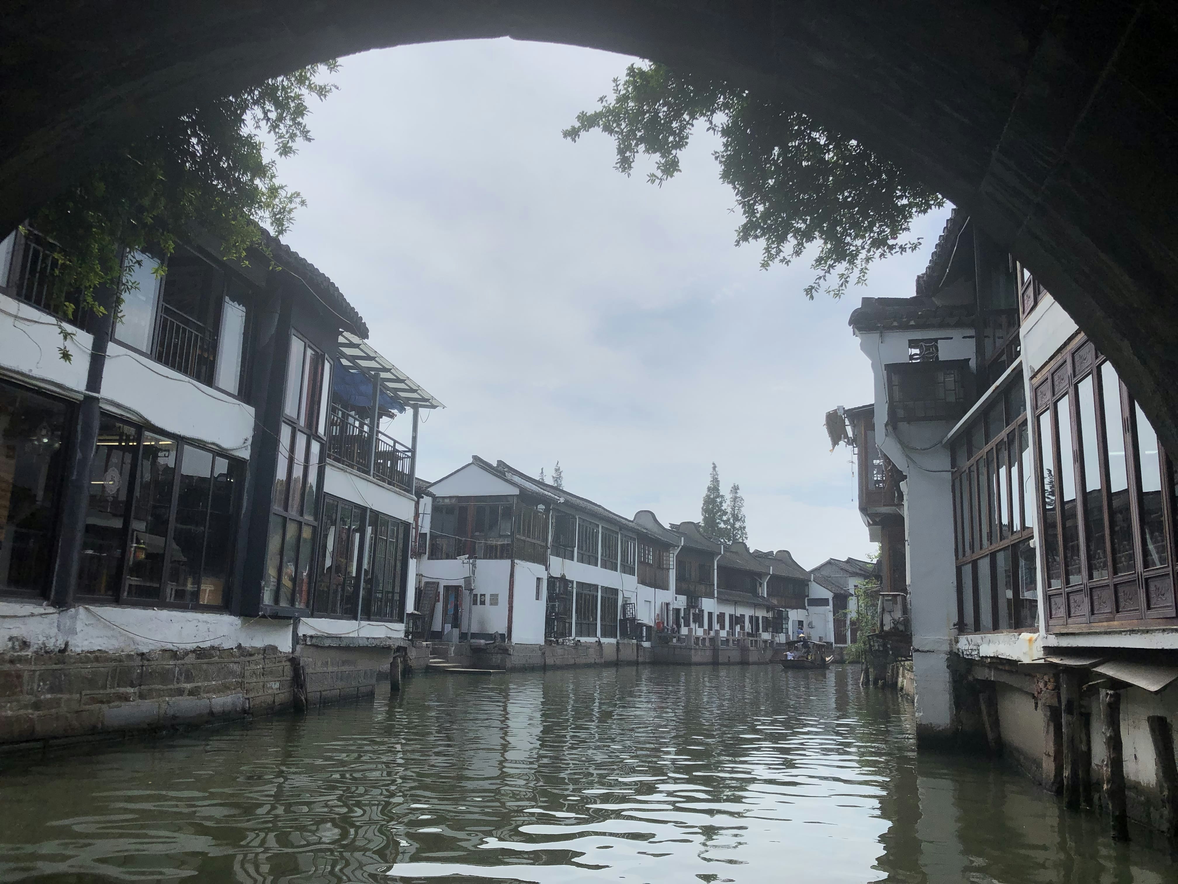 a river running through a city next to tall buildings