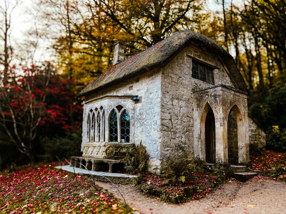 a small stone building with a small porch