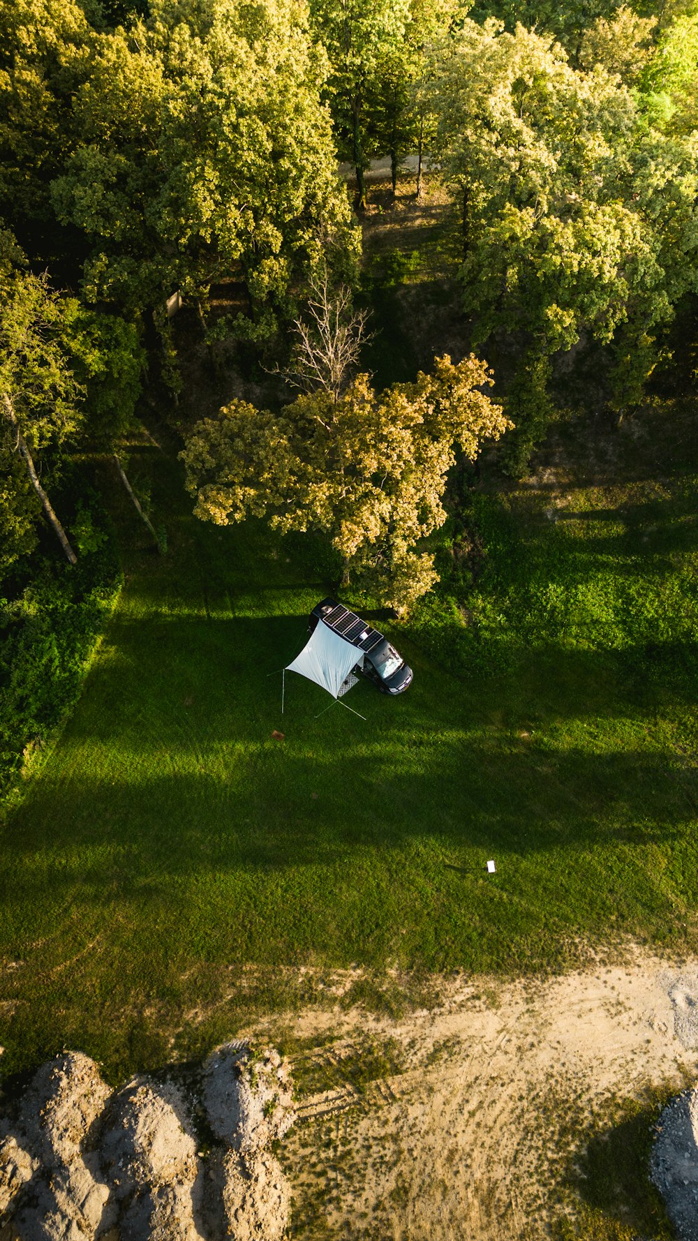 an aerial view of a tent set up in the middle of a field
