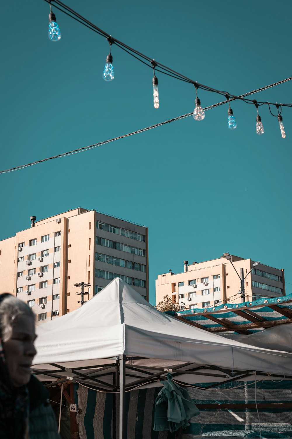 a white tent with lights hanging from it's sides