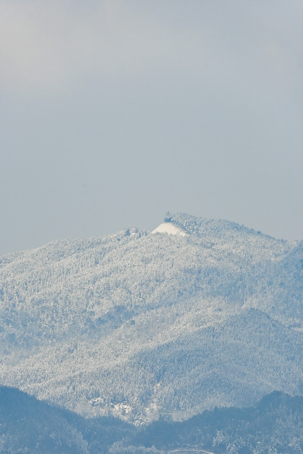 a large mountain covered in snow in the distance