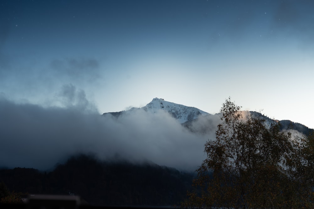 a view of a mountain covered in clouds