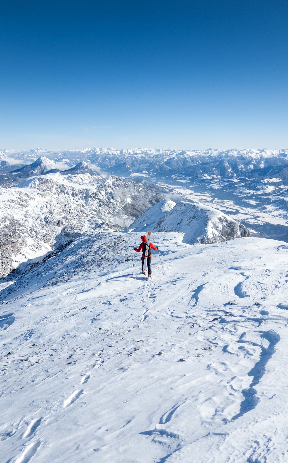 a person standing on top of a snow covered slope