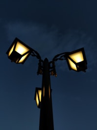 a street light with three lights on each of it's sides