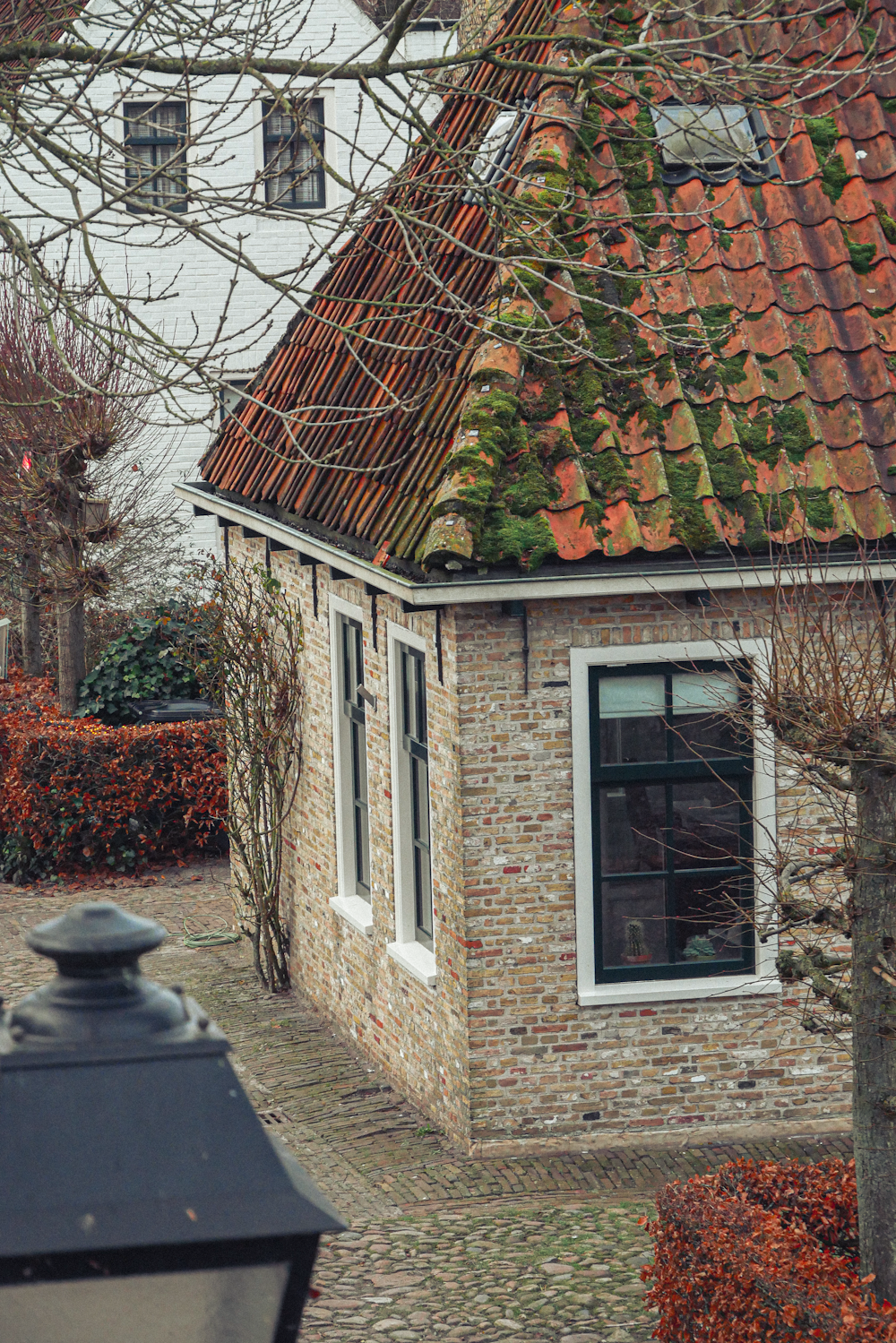 a brick house with a red tiled roof